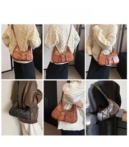 Détails du sac sous le bras marron vintage montrant le cuir vieilli et les boucles