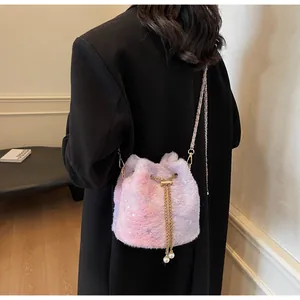 Detail of plush gradient bucket bag with star patterns, chain drawstring and pearl charms
