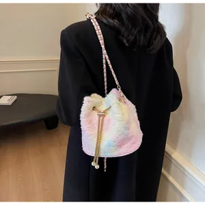 Detail of colorful plush bucket bag with golden chain strap and pearl drawstring accents