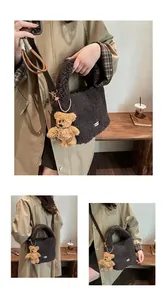 Detail of dark brown faux fur bucket bag with plush bear charm and lamb wool texture