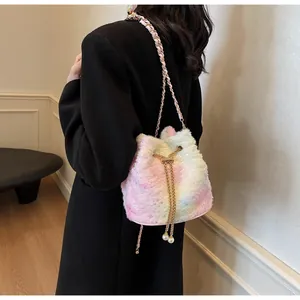 Detail of plush gradient bucket bag featuring large pearls and gold chain strap