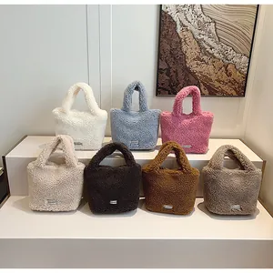 Plush faux fur bucket bags in multiple colors with metallic brand plates