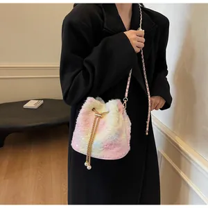 Close-up of colorful plush bucket bag with shiny sequins and pearl drawstring detail