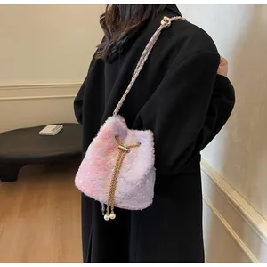 Detail of plush gradient bucket bag with star textures and pearl drawstring closure