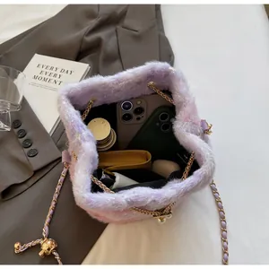 Detail view showing large interior capacity of purple plush drawstring bucket bag with sequins