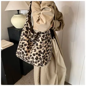 Detailed view of leopard print shoulder bag with plush texture on a model shoulder