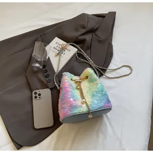Macro shot of fluffy rainbow plush bucket bag with star patterns and pearl chain strap