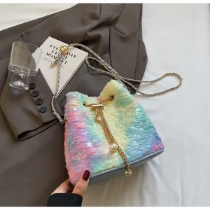 Detail of plush rainbow bucket bag with star patterns and large pearl drawstring accents