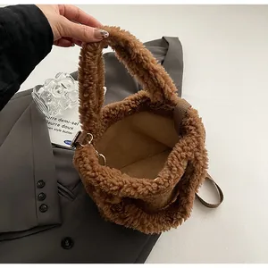Detailed close-up of brown plush bucket bag showing soft teddy faux fur and interior lining