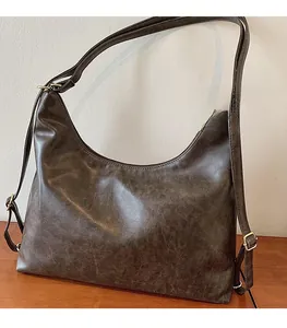 Detail showing the vintage dark brown hobo bag with oil wax leather texture and metal buckle