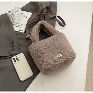Detailed macro view of mocha faux fur bucket bag texture with CLEAR K patch and strap