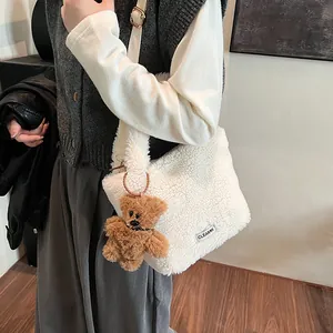 White fuzzy lamb wool bucket bag for women with cute bear charm and adjustable strap
