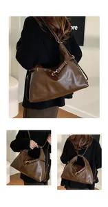 Close-up of large brown tote bag showing gold hardware and smooth faux leather texture