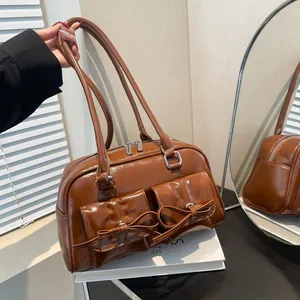 Brown faux leather shoulder bag with bow details and front pockets in balletcore style