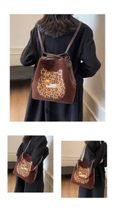 Detail view of brown vintage tote with leopard embroidery and versatile shoulder straps