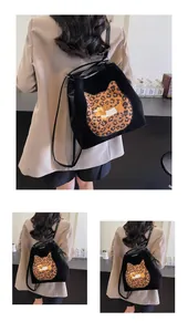 Detail of black backpack featuring leopard cat patch and Fun The Girl embroidery detail