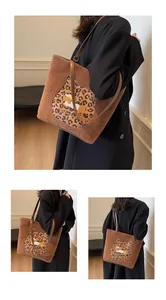 Detailed close-up of brown suede tote bag featuring leopard cat patch and cartoon detail