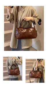Detail view of vintage brown leather tote showing texture, stitching and side pockets