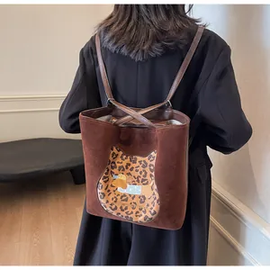 Brown suede backpack with leopard cat patch and cartoon dog embroidery on model back
