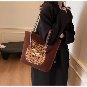 Detail of suede tote bag with leopard print cat patch and HONEYS THE WORLD embroidery