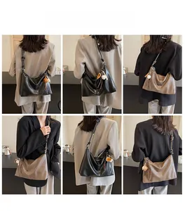 Fashionable PU leather hobo bag featuring wide strap and tassel baseball charm detail