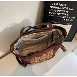 Detail view of large leopard tote bag with satin lining and internal zipper pocket