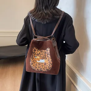 Brown patchwork backpack with animal embroidery and lettering for autumn style