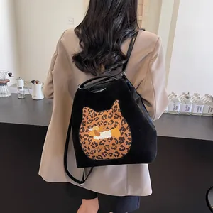 Minimalist black tote backpack with leopard cat patch and cartoon dog embroidery