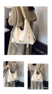 Detail of cream oversized tote bag showing leather texture and gold hardware accents