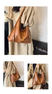 Macro detail of brown hobo bag showing high-quality leather texture and metal buckle