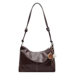 Retro dark brown leather bucket bag with white stitching and baseball charm