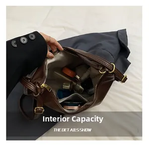 Macro detail of the internal capacity showing brown leather tote bag with various cosmetics