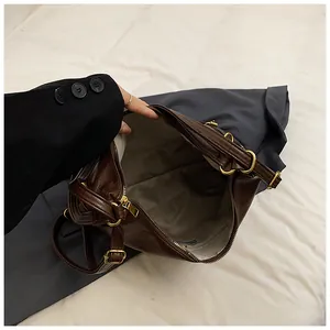 Detail view of large brown tote bag showing spacious interior with light fabric lining