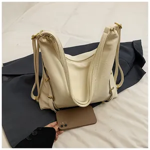 Detailed shot of large cream tote bag with lychee texture and gold-tone hardware detail