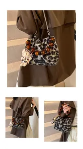 Detail of leopard print faux fur bucket bag with amber beads and metal chain strap