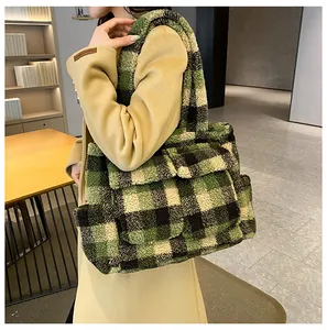 Detail shot of green checkered faux shearling tote bag with fuzzy texture and flap pockets