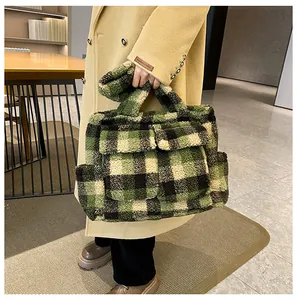 Detail of green and black checkered plush tote bag with double front flap pockets