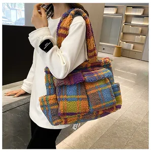 Detail of colorful plaid faux fur tote bag showing plush texture and front pockets