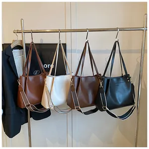Detail view of large tote bags in multiple colors with stylish wide striped shoulder straps