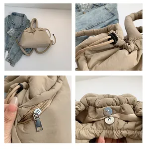 Detail of quilted puffer tote bag featuring drawstring closure and magnetic snap buckle