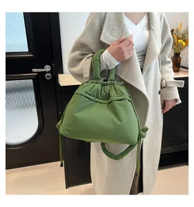 Close-up of grass green puffy tote bag with drawstring closure and quilted texture