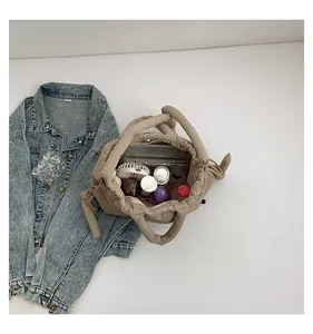 Top view of beige puffy tote bag showing large capacity with laptop and daily essentials
