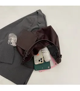 Deep brown tote bag detail showing large interior space for a phone, umbrella and tablet