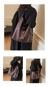 Detail of vintage brown soft leather tote bag showing texture and side zipper coin purse