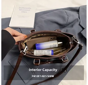Top view of dark brown leather tote interior showing high capacity and zip pocket