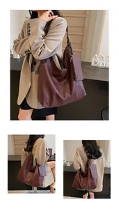 Detailed macro view of high-quality soft faux leather texture on oversized burgundy tote bag