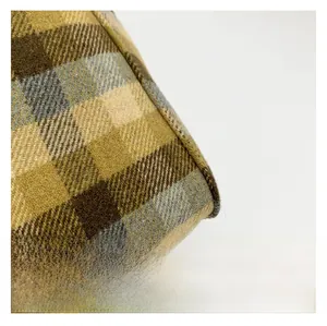 Macro shot of high-quality brown and blue plaid woven fabric texture with neat stitching