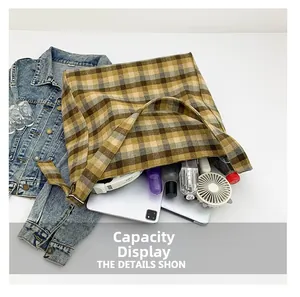 Detailed view of the checkered canvas tote bag showing its large storage capacity