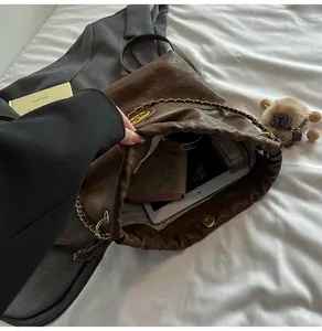 Intérieur du sac en cuir marron foncé offrant une grande capacité pour les tablettes