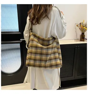Detailed view of the vintage plaid pattern on a high-capacity hobo shoulder bag